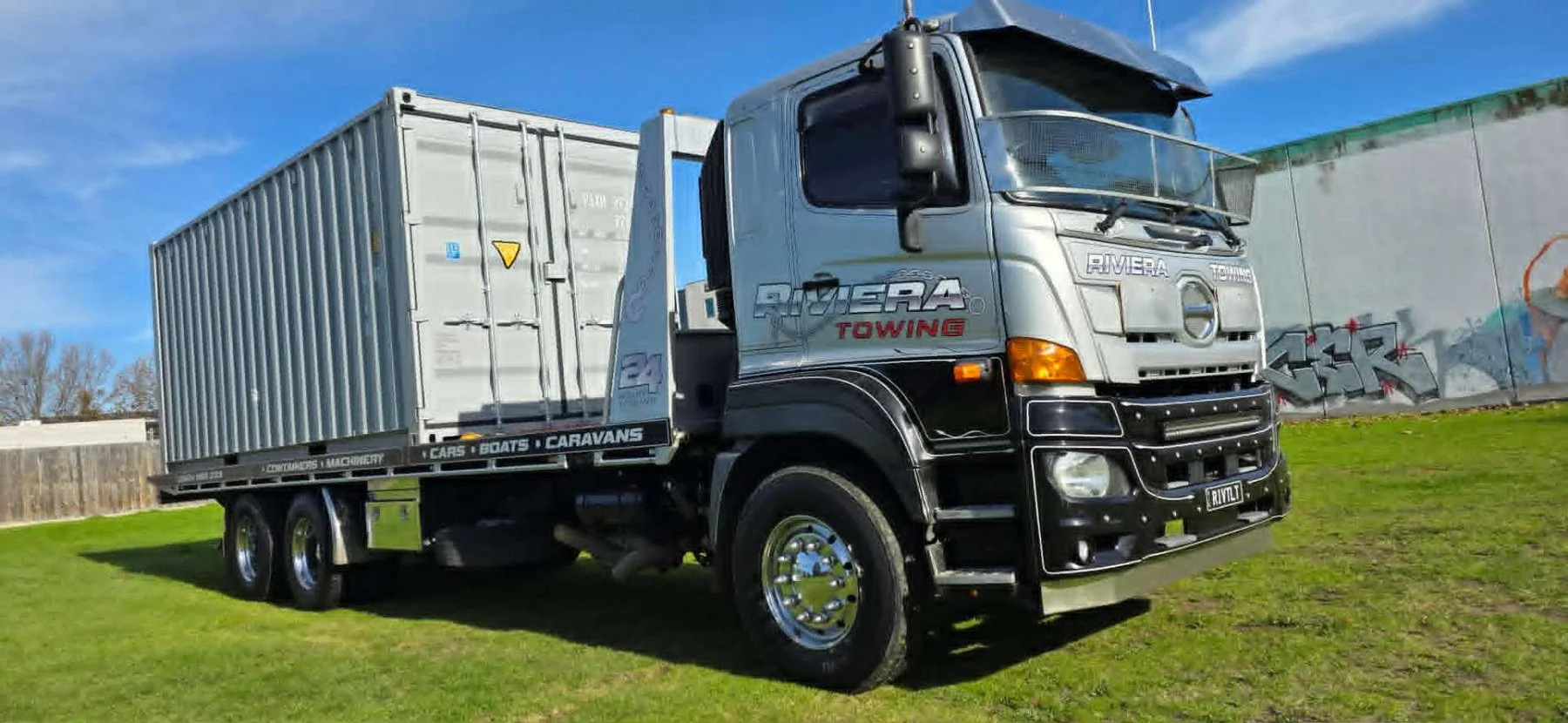 Riviera Towing — Hino tilt tray with shipping container — yard pickup in Bairnsdale & East Gippsland, Victoria